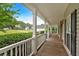 Inviting covered front porch with white railing, perfect for relaxing and enjoying the neighborhood views at 345 Riverstone Dr, Hiram, GA 30141