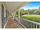 Inviting covered front porch with white railing, perfect for relaxing and enjoying the neighborhood views at 345 Riverstone Dr, Hiram, GA 30141