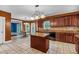 Bright eat-in kitchen featuring an island with granite countertops, stainless appliances, and access to the living room at 345 Riverstone Dr, Hiram, GA 30141