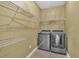 Functional laundry room with shelving and new washer and dryer units at 345 Riverstone Dr, Hiram, GA 30141