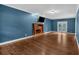 Spacious living room with hardwood floors, brick fireplace, and access to outdoor patio at 345 Riverstone Dr, Hiram, GA 30141
