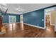 Spacious living room featuring hardwood floors, blue accent wall and double-door access to the backyard at 345 Riverstone Dr, Hiram, GA 30141