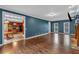Open concept living room with hardwood floors that connect to the kitchen and features a stone fireplace at 345 Riverstone Dr, Hiram, GA 30141