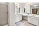 Bathroom featuring double vanities, a glass-enclosed shower, and ample space for a luxurious and functional design at 4435 Grove Nw Dr, Acworth, GA 30101