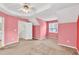 Large bedroom showcasing a neutral carpet, a bright window, and a ceiling fan for optimal comfort and style at 4435 Grove Nw Dr, Acworth, GA 30101
