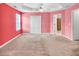 Spacious bedroom featuring a tray ceiling, ceiling fan, and an en suite bathroom for added privacy and convenience at 4435 Grove Nw Dr, Acworth, GA 30101