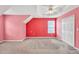 Spacious bedroom features vibrant pink walls and natural light, offering a unique and cheerful ambiance at 4435 Grove Nw Dr, Acworth, GA 30101