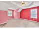 Well-lit bedroom complete with a ceiling fan, windows, and neutral carpet, offering a comfortable and inviting space at 4435 Grove Nw Dr, Acworth, GA 30101