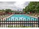 Large, inviting community pool with ample lounge chairs and umbrellas, surrounded by lush greenery and playground at 4435 Grove Nw Dr, Acworth, GA 30101