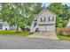 Charming two-story home featuring neutral siding, black shutters, two-car garage, and a well-manicured front lawn at 4435 Grove Nw Dr, Acworth, GA 30101