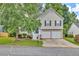 Charming two-story home featuring neutral siding, black shutters, two-car garage, and a well-manicured front lawn at 4435 Grove Nw Dr, Acworth, GA 30101