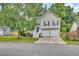 Charming two-story home featuring neutral siding, black shutters, two-car garage, and a well-manicured front lawn at 4435 Grove Nw Dr, Acworth, GA 30101