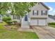 Charming two-story home featuring neutral siding, black shutters, two-car garage, and a well-manicured front lawn at 4435 Grove Nw Dr, Acworth, GA 30101