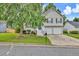 Charming two-story home featuring neutral siding, black shutters, two-car garage, and a well-manicured front lawn at 4435 Grove Nw Dr, Acworth, GA 30101