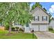 Charming two-story home featuring neutral siding, black shutters, two-car garage, and a well-manicured front lawn at 4435 Grove Nw Dr, Acworth, GA 30101