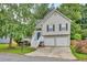 Charming two-story home featuring neutral siding, black shutters, two-car garage, and a well-manicured front lawn at 4435 Grove Nw Dr, Acworth, GA 30101