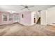 Large living room space with ceiling fan, windows, and staircase at 4435 Grove Nw Dr, Acworth, GA 30101