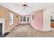 Open living room with a ceiling fan, windows and a view to the kitchen at 4435 Grove Nw Dr, Acworth, GA 30101