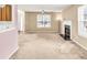 Open living room with fireplace, large windows, and neutral paint at 4435 Grove Nw Dr, Acworth, GA 30101