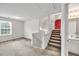 Open living room with carpeted floors and stairs leading to the next level, offering a spacious layout at 4435 Grove Nw Dr, Acworth, GA 30101