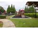 Community playground with a slide and climbing structure, set in a grassy area with mature trees at 4435 Grove Nw Dr, Acworth, GA 30101