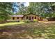 Well-maintained backyard with a spacious lawn, wooden fence, and a cozy deck ideal for relaxation and enjoying the outdoors at 217 Cedar Trl, Jonesboro, GA 30238