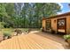Exterior of home with a wooden deck, wooded lot, and a door to access the backyard at 217 Cedar Trl, Jonesboro, GA 30238