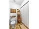 Cozy bathroom featuring a white toilet, wooden shelving unit, and a shower with a white curtain at 217 Cedar Trl, Jonesboro, GA 30238