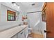 Bathroom with updated vanity, granite countertop, tile floor, tub, and shower at 217 Cedar Trl, Jonesboro, GA 30238