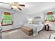 Bedroom with neutral decor, carpet, two large windows, and bench at 217 Cedar Trl, Jonesboro, GA 30238