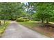 Long driveway leading to a well-maintained home with mature trees and manicured lawn at 217 Cedar Trl, Jonesboro, GA 30238
