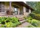 Charming front porch with stone steps, wood accents, and lush landscaping at 217 Cedar Trl, Jonesboro, GA 30238