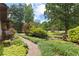 Landscaped front yard with a stone pathway, lush greenery, and shade trees at 217 Cedar Trl, Jonesboro, GA 30238
