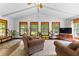 Bright living room with wood floors, beamed ceilings, and three large windows with wood trim at 217 Cedar Trl, Jonesboro, GA 30238