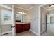 This bathroom has a wood vanity with granite countertop and a large mirror at 7804 Gusty Trl, Douglasville, GA 30135