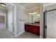 Well-lit bathroom boasts dark wood vanity and tiled shower, perfect for relaxation at 7804 Gusty Trl, Douglasville, GA 30135