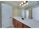 This bathroom vanity is a light wood with long countertop and a large mirror at 7804 Gusty Trl, Douglasville, GA 30135