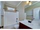Clean bathroom with white fixtures, shower-tub combo, and vanity at 7804 Gusty Trl, Douglasville, GA 30135