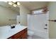 Neat and clean bathroom featuring a large vanity and a shower tub combo at 7804 Gusty Trl, Douglasville, GA 30135