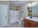 Full bath features a white vanity, tiled floor, tub-shower, and framed mirror at 7804 Gusty Trl, Douglasville, GA 30135