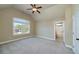 Bright bedroom with a ceiling fan, large window and ensuite bathroom at 7804 Gusty Trl, Douglasville, GA 30135