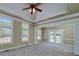 Large bedroom with tray ceiling, and windows providing natural light at 7804 Gusty Trl, Douglasville, GA 30135
