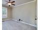 Spacious bedroom with neutral carpet, ceiling fan, and ample natural light at 7804 Gusty Trl, Douglasville, GA 30135