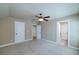 Spacious bedroom with neutral walls, a ceiling fan, and multiple doors at 7804 Gusty Trl, Douglasville, GA 30135
