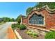 The Estates at Hurricane Pointe community sign showcasing beautiful landscaping and brick architecture at 7804 Gusty Trl, Douglasville, GA 30135