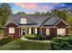 Charming brick home featuring detailed architecture and manicured landscaping at 7804 Gusty Trl, Douglasville, GA 30135