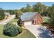 Charming brick home featuring an attached garage and well-maintained landscaping on a sunny day at 7804 Gusty Trl, Douglasville, GA 30135