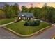 Charming brick home with lush lawn and mature landscaping during twilight at 7804 Gusty Trl, Douglasville, GA 30135