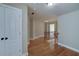 Hallway featuring hardwood floors and a staircase, offering a stylish transition space at 7804 Gusty Trl, Douglasville, GA 30135