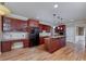 Kitchen featuring a breakfast bar, granite counters, dark wood cabinetry, and stainless steel appliances at 7804 Gusty Trl, Douglasville, GA 30135